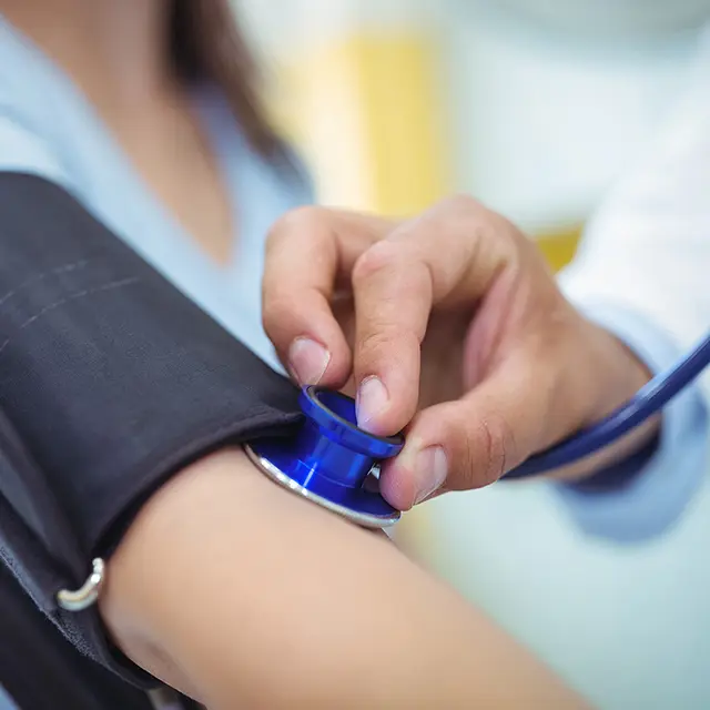 Checking blood pressure on patient