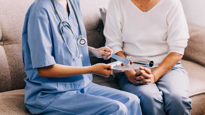 Doctor holding hands with patient